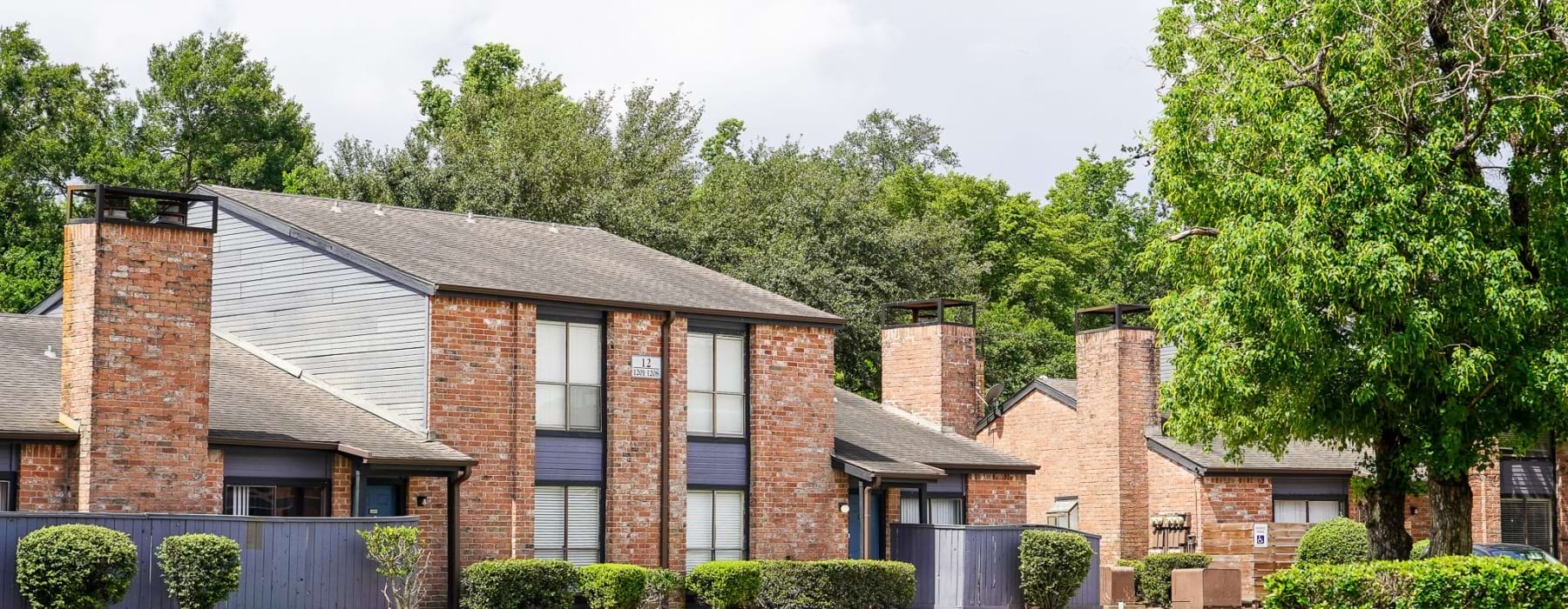 brick apartment buildings with trees